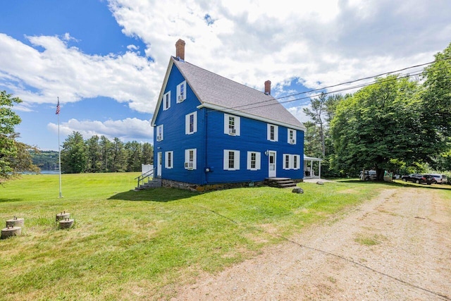 view of property exterior featuring a lawn