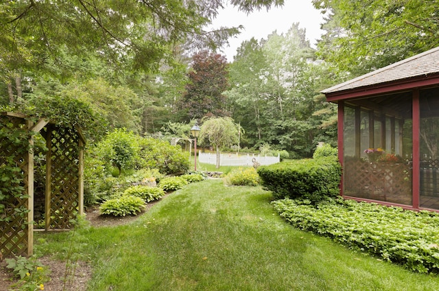 view of yard with a sunroom