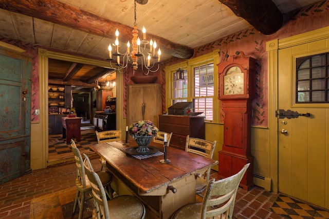 dining space with beamed ceiling, a notable chandelier, wood walls, and a baseboard radiator