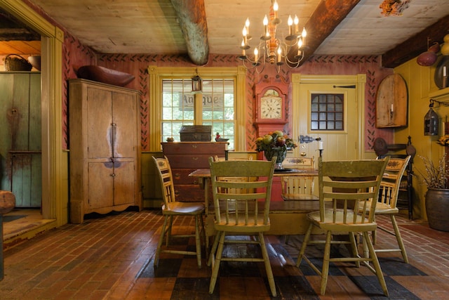 dining space with beamed ceiling, a chandelier, and wooden ceiling