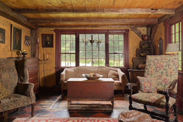 sitting room featuring beam ceiling, an inviting chandelier, and wood ceiling