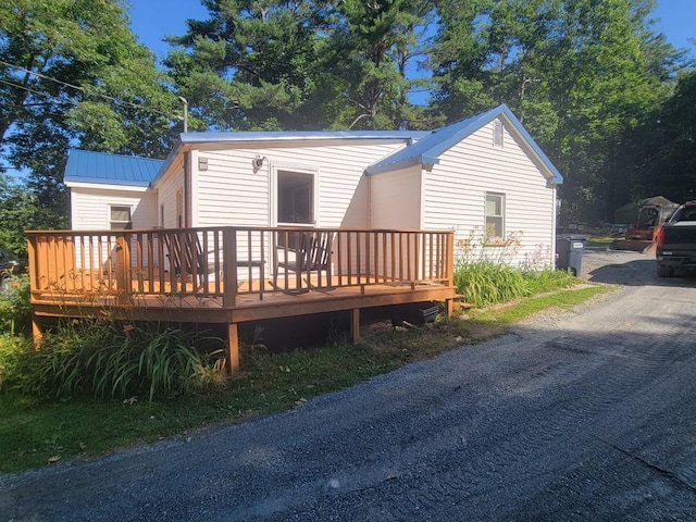 rear view of property featuring a wooden deck