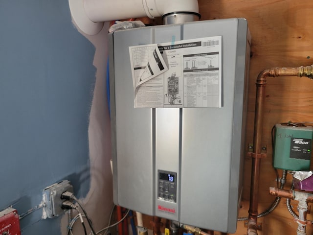 utility room featuring tankless water heater