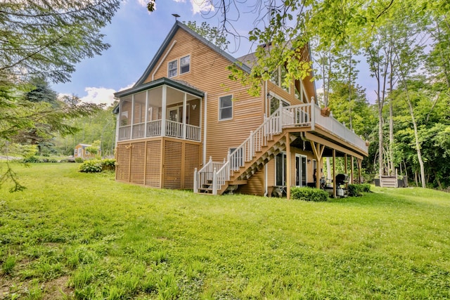 rear view of house with a wooden deck, a yard, and a sunroom