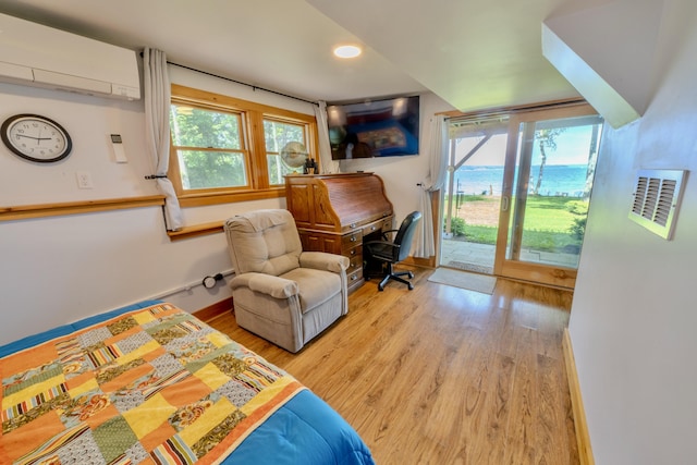 interior space featuring light wood-type flooring and a wall mounted air conditioner