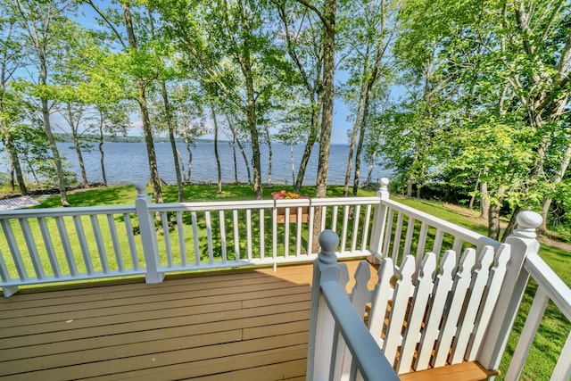 deck with a lawn and a water view