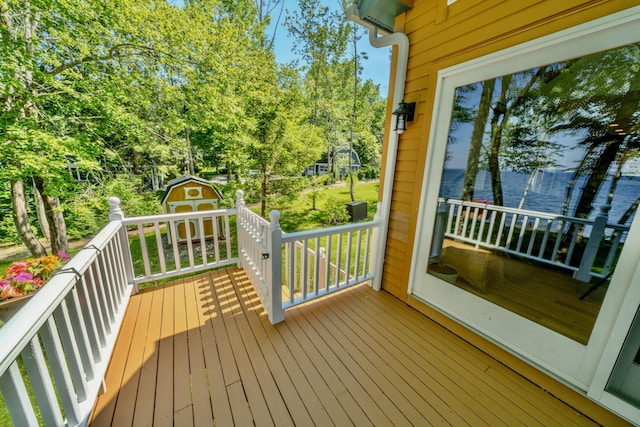 wooden terrace featuring a shed