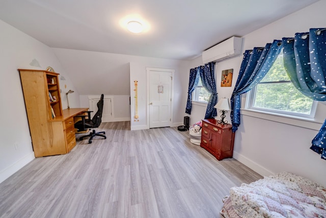 office space featuring lofted ceiling, light hardwood / wood-style floors, and a wall mounted air conditioner