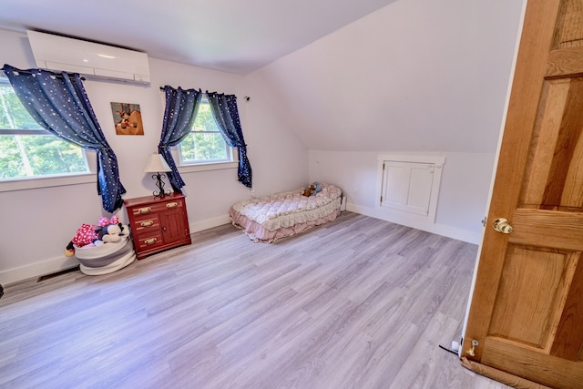 unfurnished bedroom featuring lofted ceiling, light hardwood / wood-style flooring, and an AC wall unit