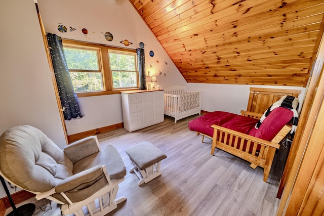 bedroom with vaulted ceiling, wooden ceiling, and light hardwood / wood-style floors