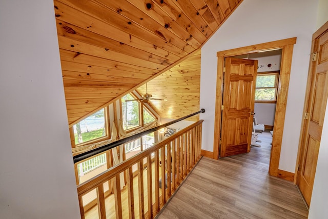 hallway with lofted ceiling, wood ceiling, and light wood-type flooring