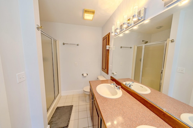 bathroom with toilet, vanity, tile patterned flooring, and a shower with door