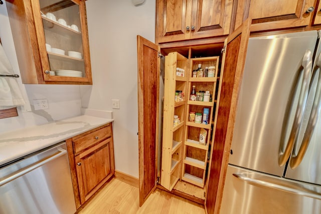 kitchen with light wood-type flooring and stainless steel appliances