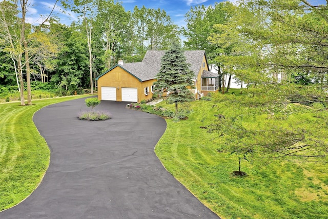 view of front of house featuring a garage and a front lawn