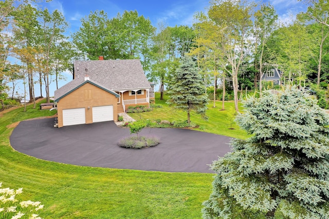 view of side of property with a yard and a garage