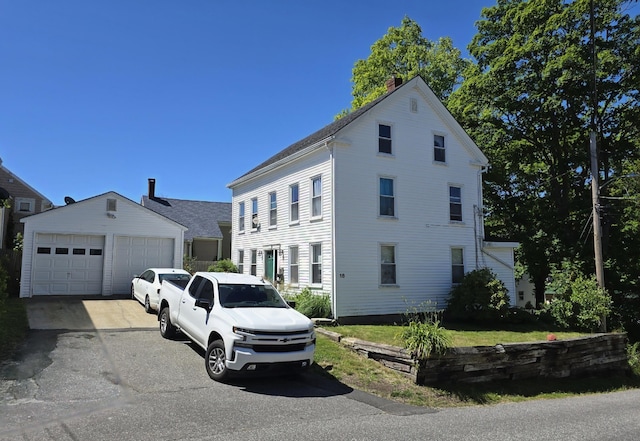 view of front of property featuring an outbuilding and a garage