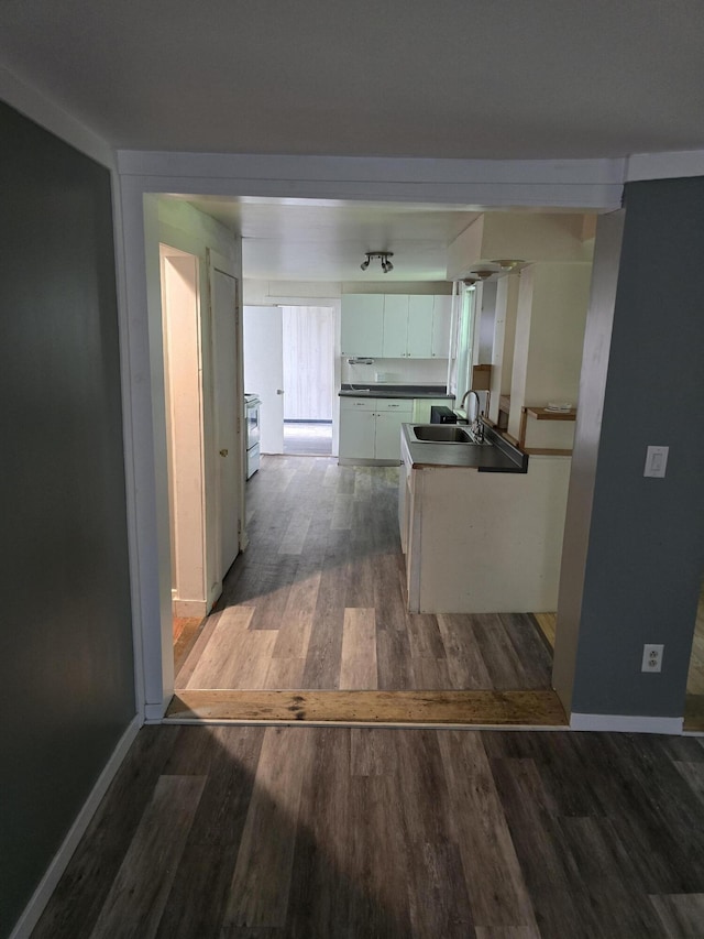 corridor featuring sink and dark hardwood / wood-style floors