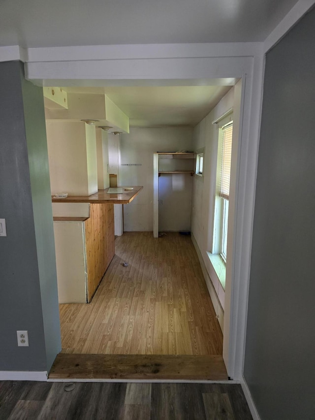 hall with hardwood / wood-style floors