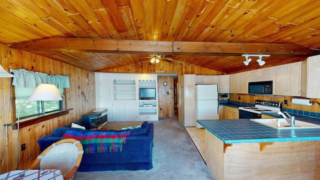 kitchen with white fridge, tile countertops, range with electric stovetop, white cabinets, and sink