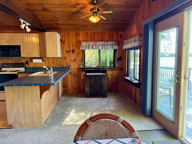 kitchen featuring wooden ceiling, tile counters, white electric range oven, and sink