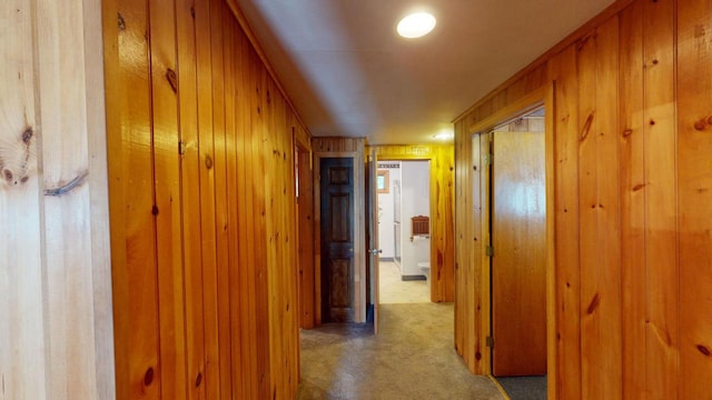 corridor featuring wood walls