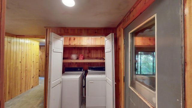 washroom featuring washer and dryer and wood walls