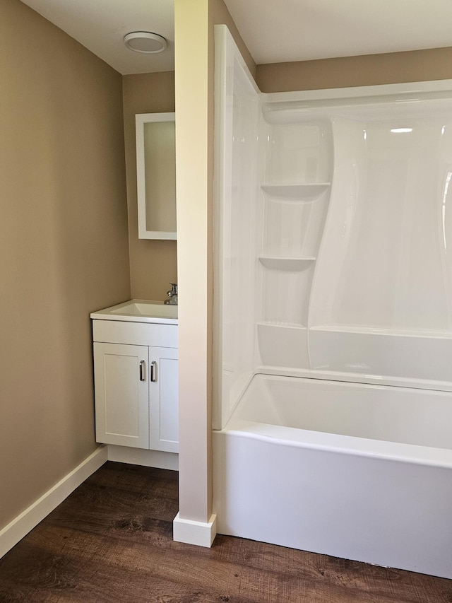 bathroom with vanity, hardwood / wood-style flooring, and  shower combination