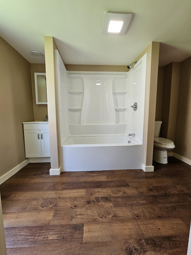 full bathroom with vanity, toilet, wood-type flooring, and washtub / shower combination