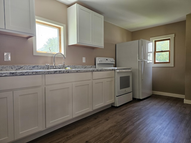 kitchen with dark hardwood / wood-style flooring, white appliances, white cabinetry, and plenty of natural light