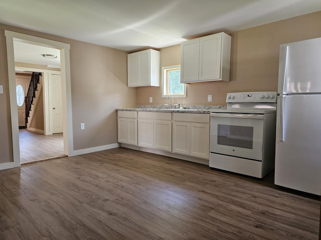 kitchen with white cabinets, sink, white appliances, and dark wood-type flooring