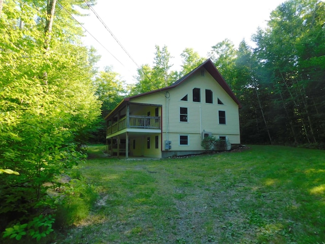 rear view of property featuring a yard