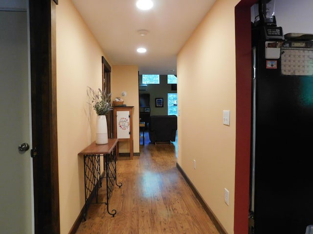 hallway with light hardwood / wood-style flooring