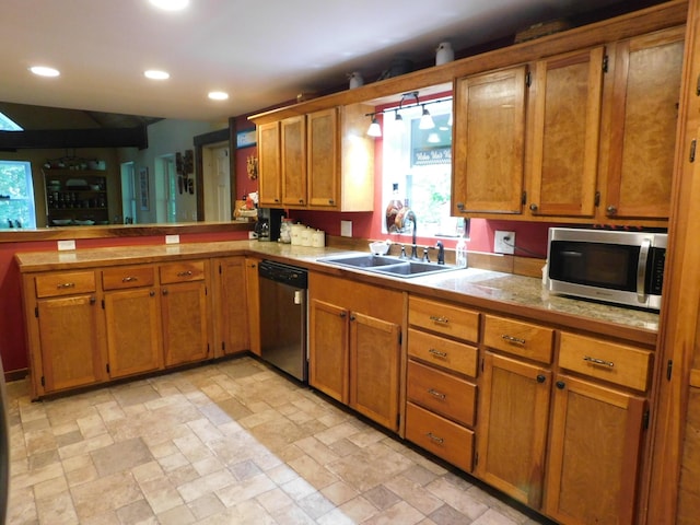 kitchen featuring stainless steel appliances, kitchen peninsula, and sink