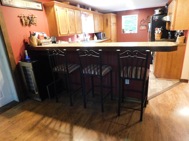 interior space featuring appliances with stainless steel finishes, light hardwood / wood-style floors, plenty of natural light, and sink