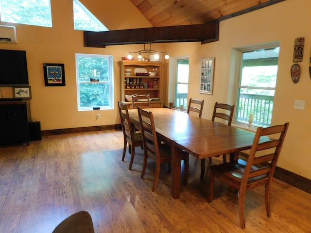 dining space featuring a wealth of natural light, hardwood / wood-style flooring, and an AC wall unit