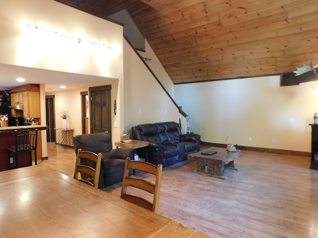 living room with lofted ceiling, wood ceiling, and light wood-type flooring