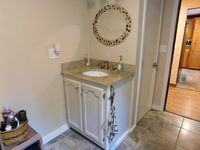 bathroom with tile patterned floors and vanity