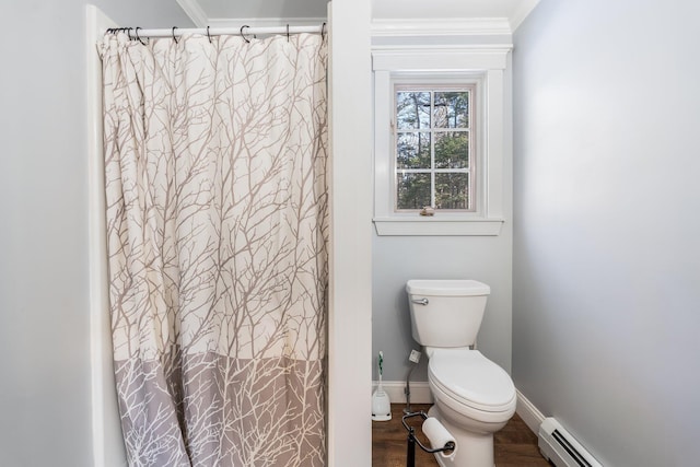 bathroom featuring wood finished floors, baseboards, ornamental molding, toilet, and baseboard heating