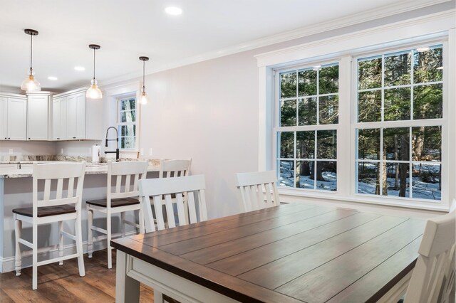 dining room featuring recessed lighting, wood finished floors, and ornamental molding