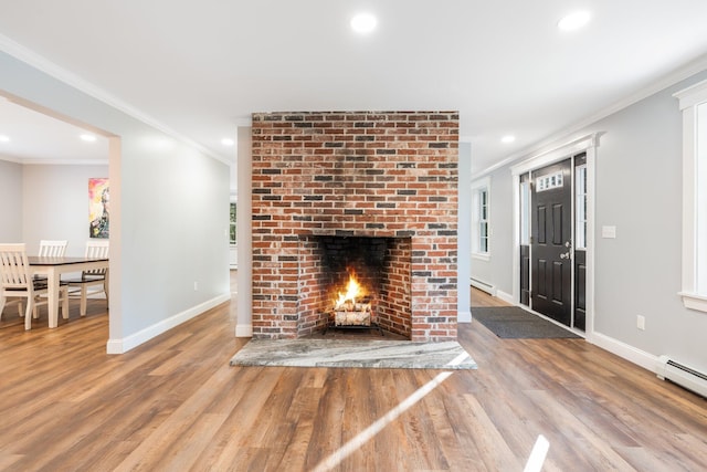 unfurnished living room featuring a fireplace, wood finished floors, and ornamental molding