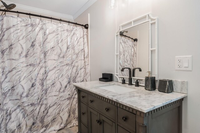 full bath with ornamental molding and vanity