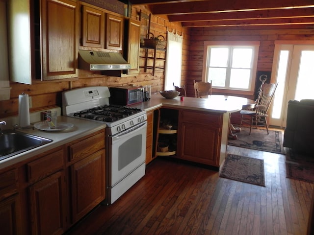 kitchen with dark hardwood / wood-style flooring, sink, white gas stove, kitchen peninsula, and beam ceiling