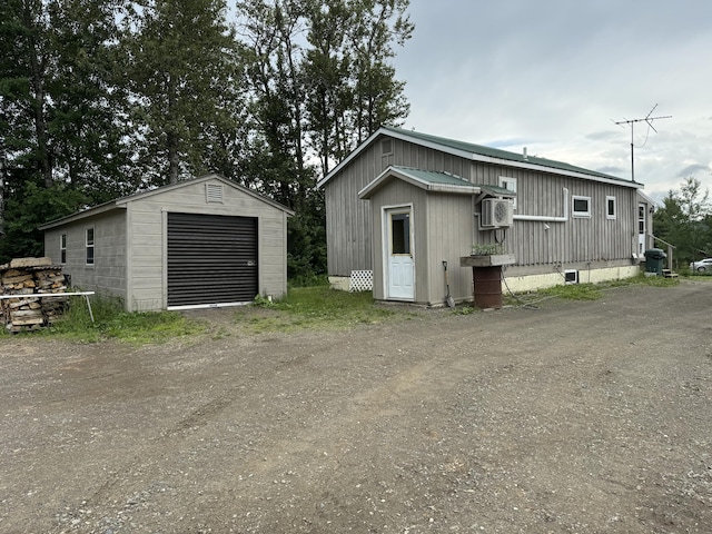 exterior space with a garage and an outdoor structure