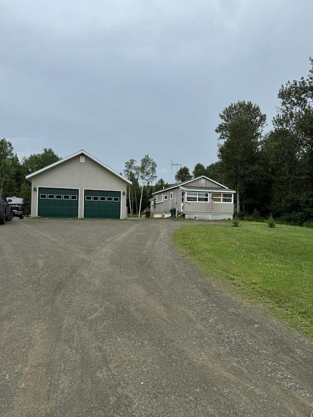 view of front of property featuring a garage, a front yard, and a porch