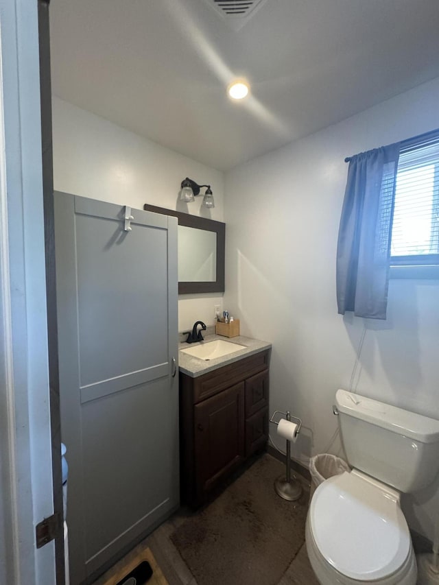 bathroom featuring toilet and vanity