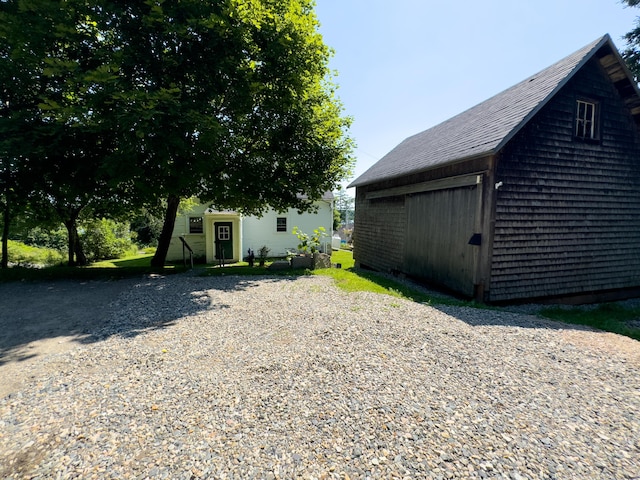 exterior space with a garage and an outdoor structure