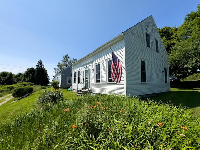 view of property exterior with a lawn