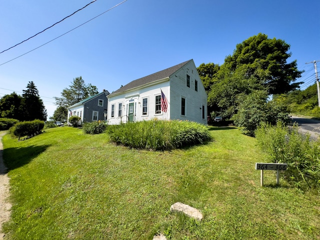 view of side of property featuring a yard