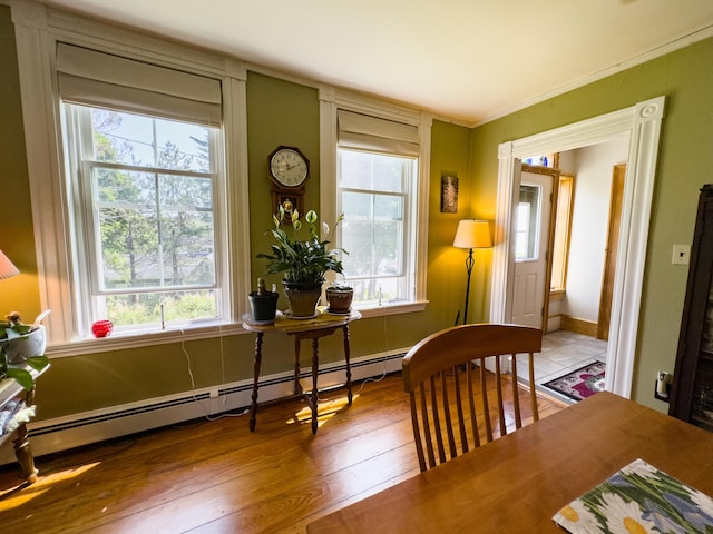 sitting room featuring wood-type flooring and a baseboard heating unit