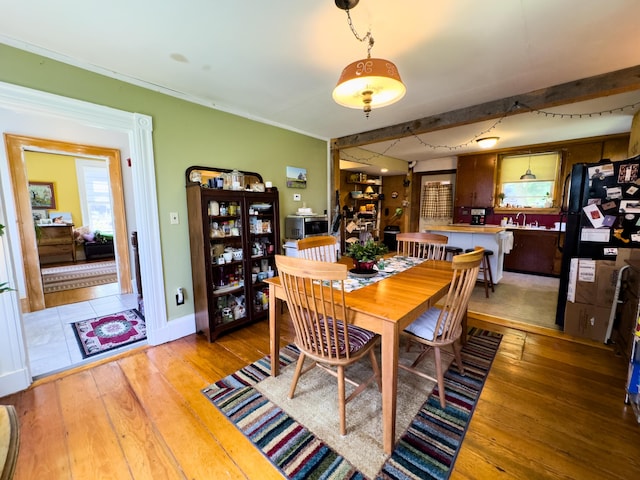 dining room featuring sink and hardwood / wood-style floors